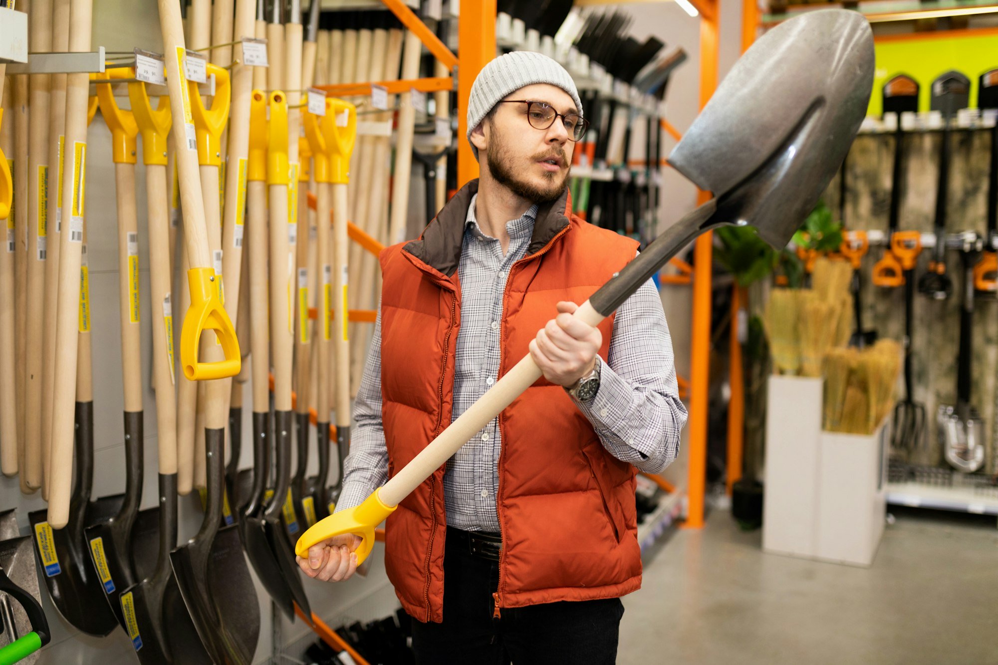 building materials stores a man chooses a new hammer